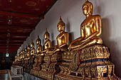 Bangkok Wat Pho, Buddha gilded statues lined in the double cloister enclosing the ubosot.  